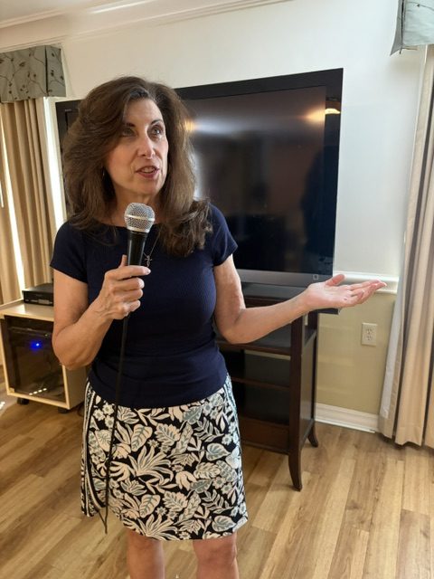 Jennifer Covello with mic at speaking event